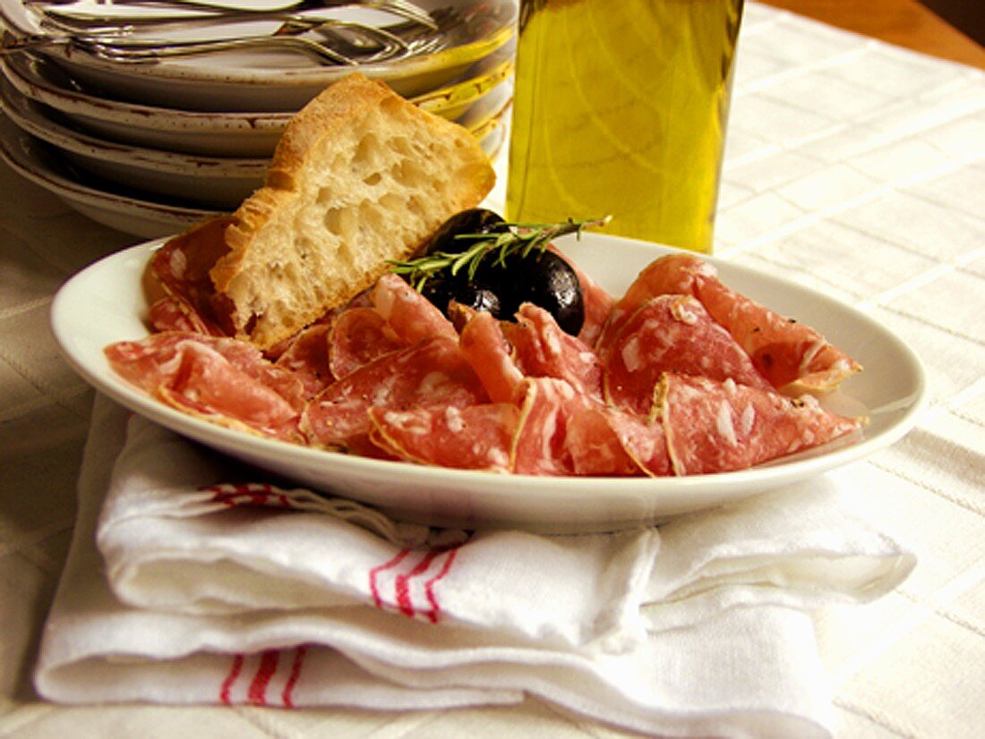 Sliced Salami with Bread and Olives
