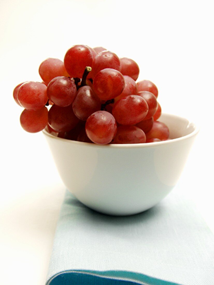 Bunch of Red Grapes in a White Bowl
