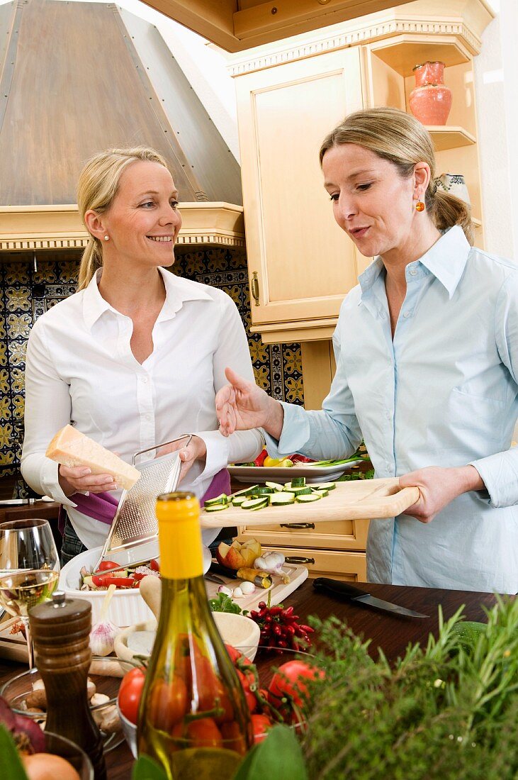 Two friends preparing food together