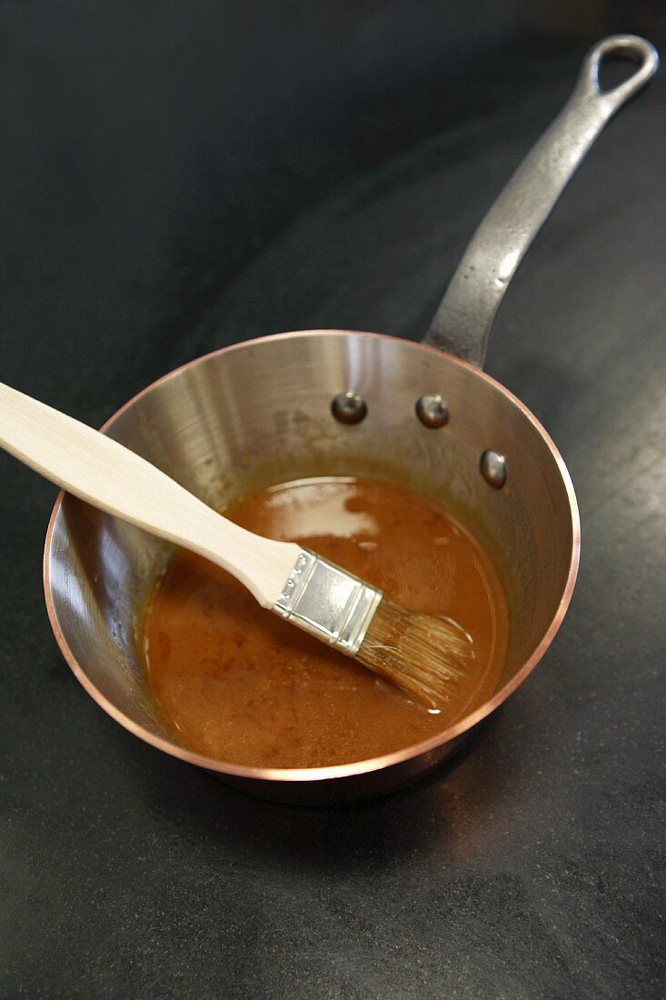 Sauce in a sauce pan with brush