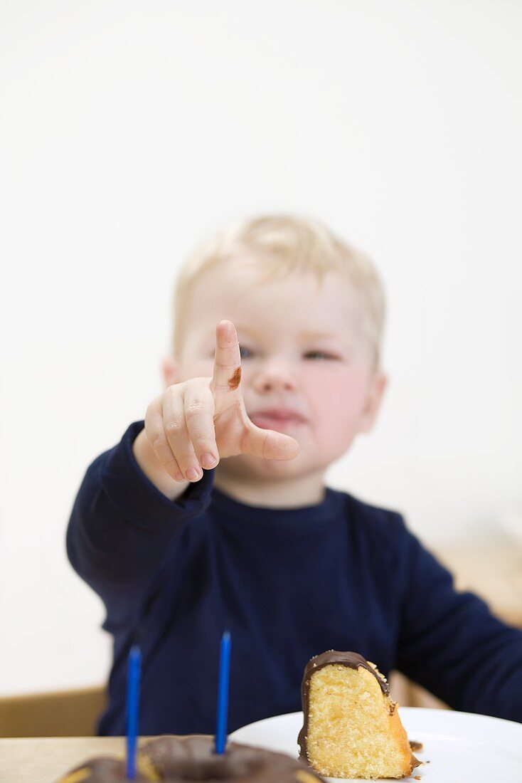 Small boy holding up fingers to show he is 2 years old