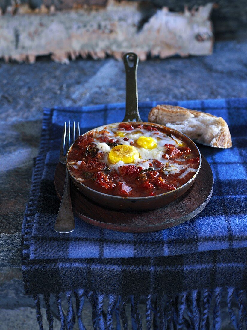 Paprika sausage with eggs in a frying pan