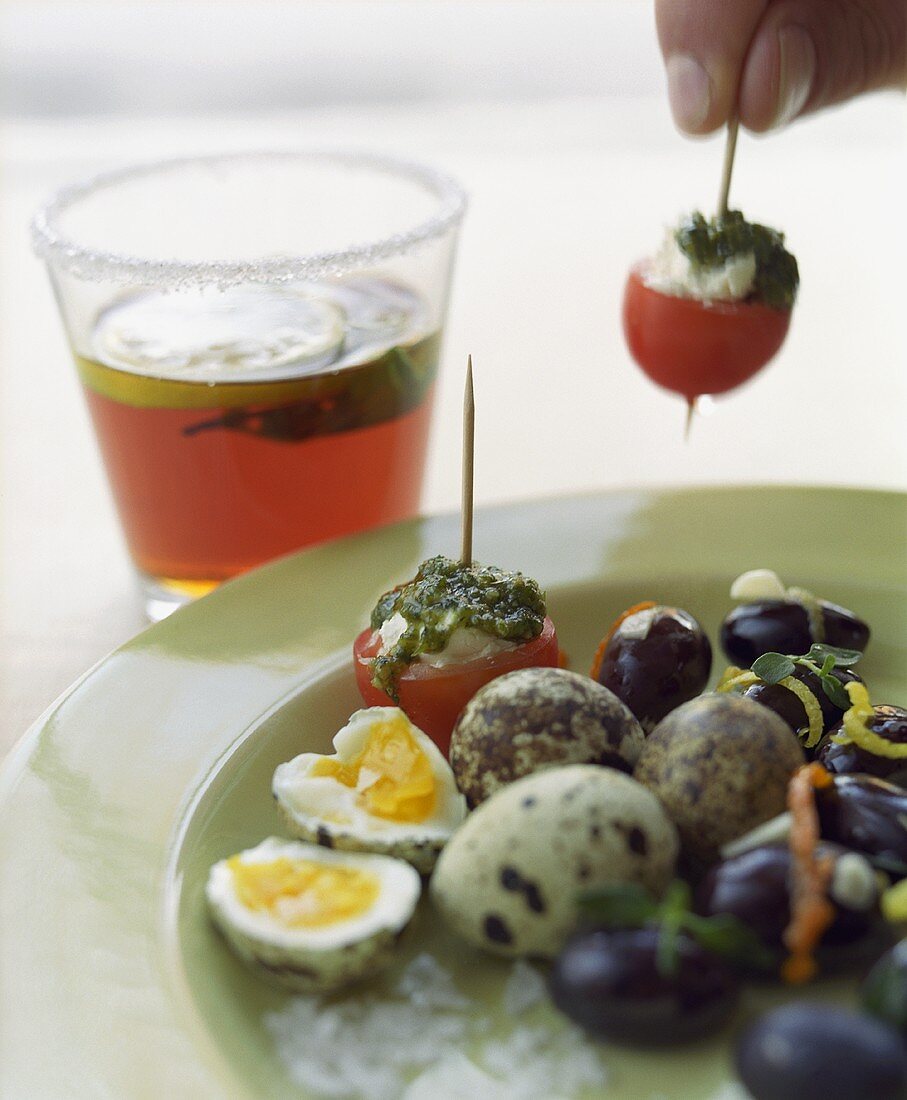 Quails' eggs, stuffed tomatoes and black olives