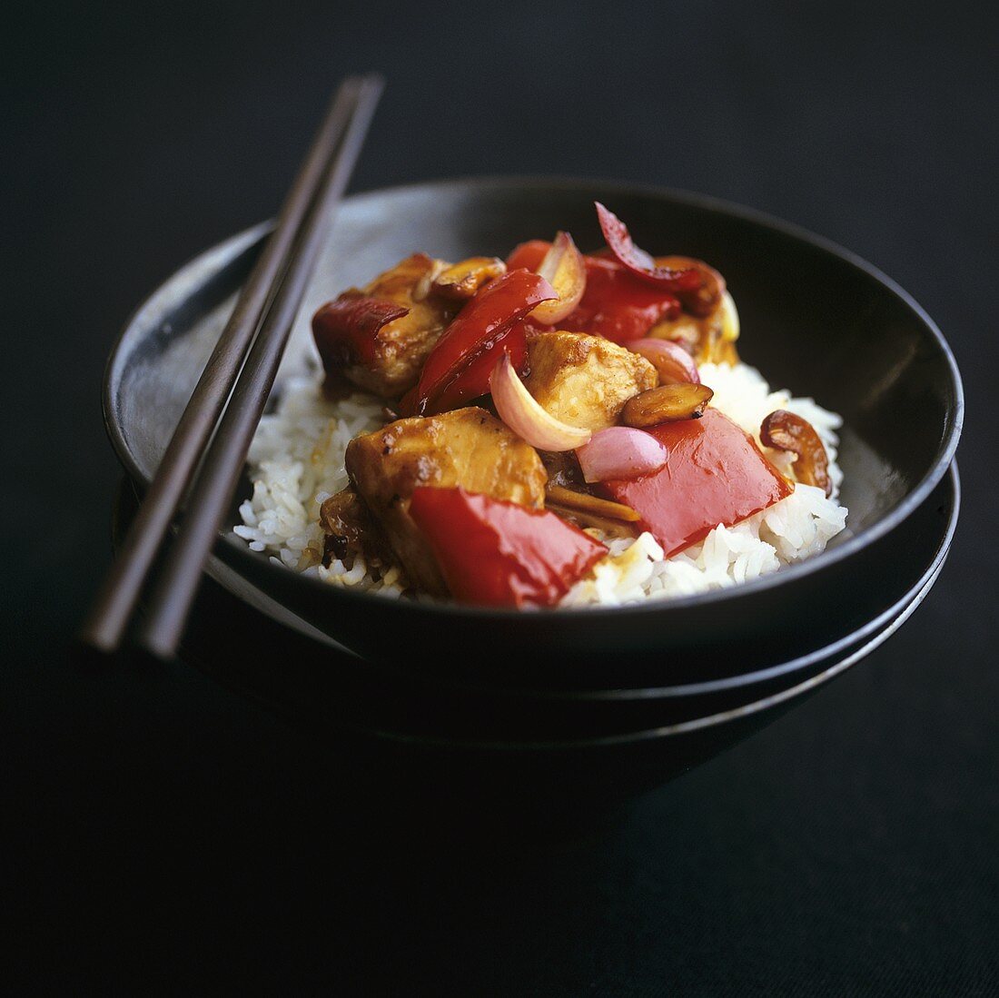 Chicken with red peppers on rice