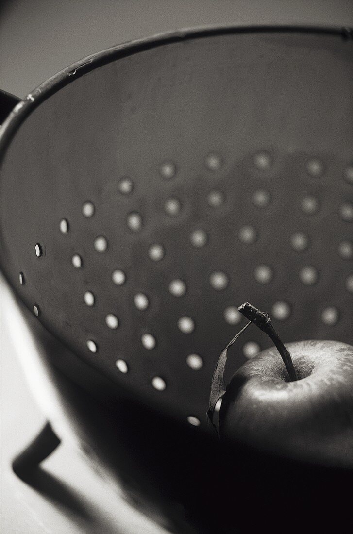 An apple in a colander