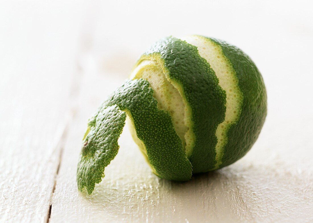 A half-peeled lime