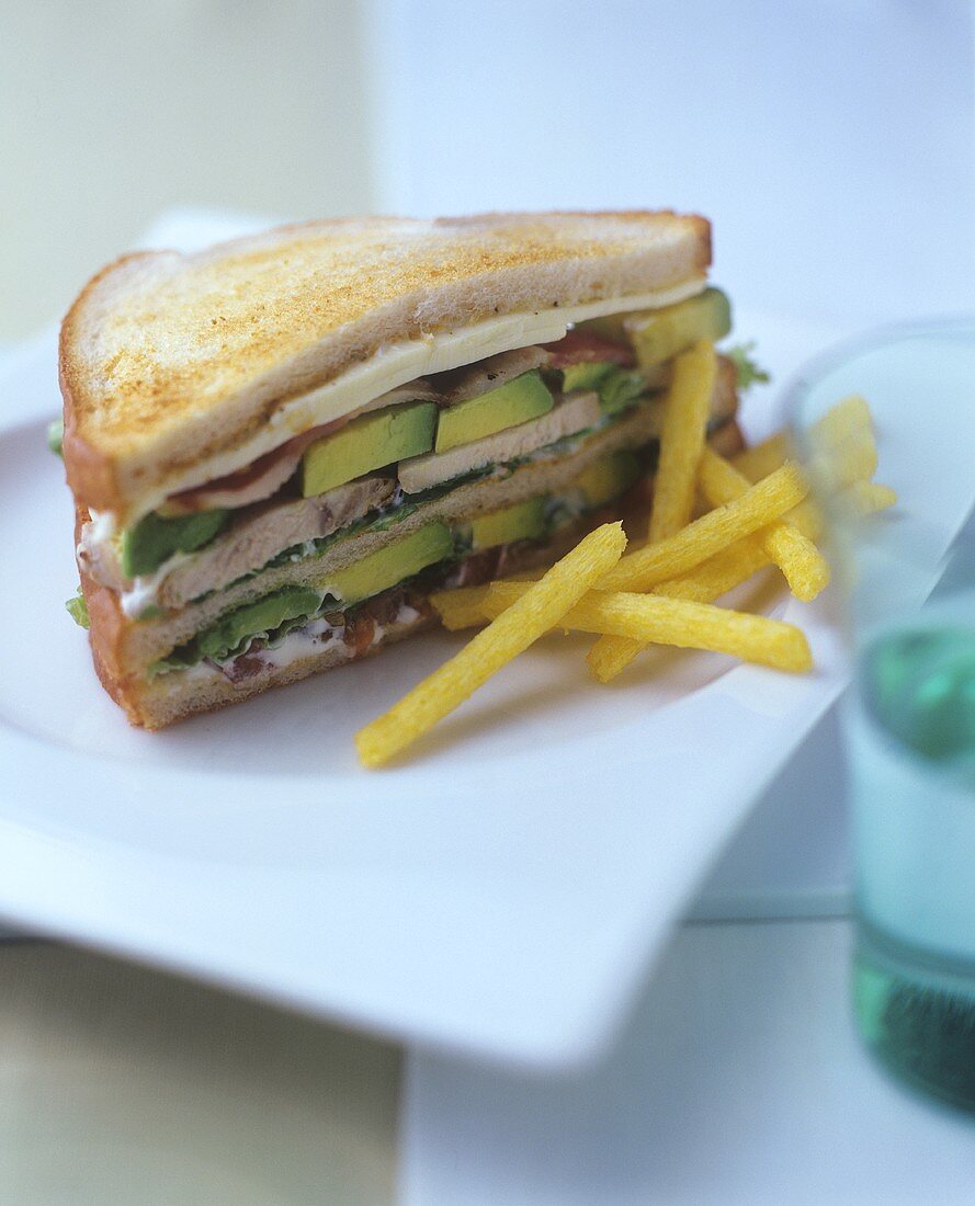 Double-decker sandwich, chips beside it