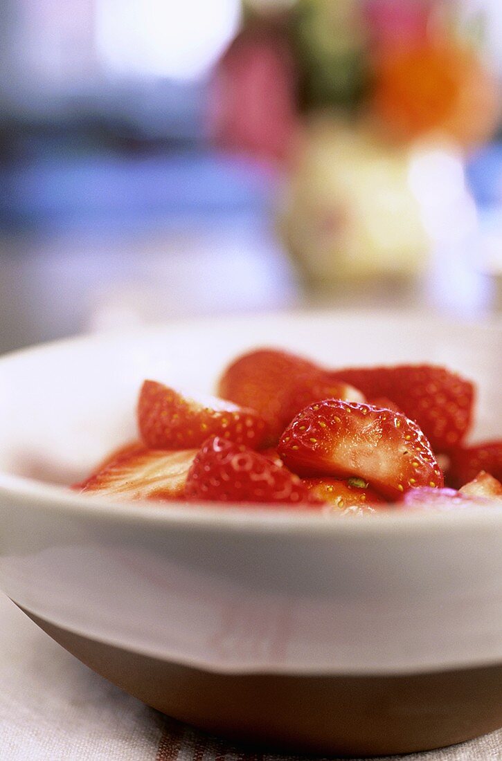 Fresh, sliced strawberries in a bowl