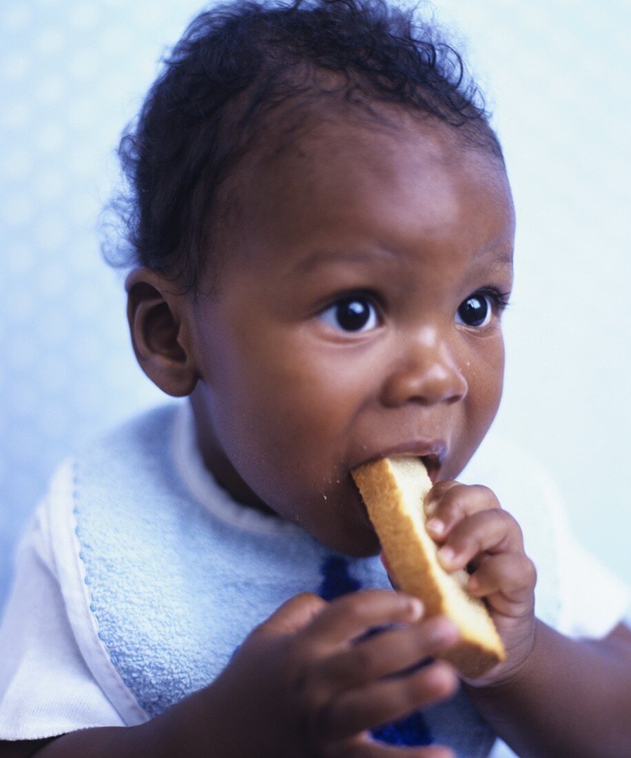 Baby chewing on a rusk