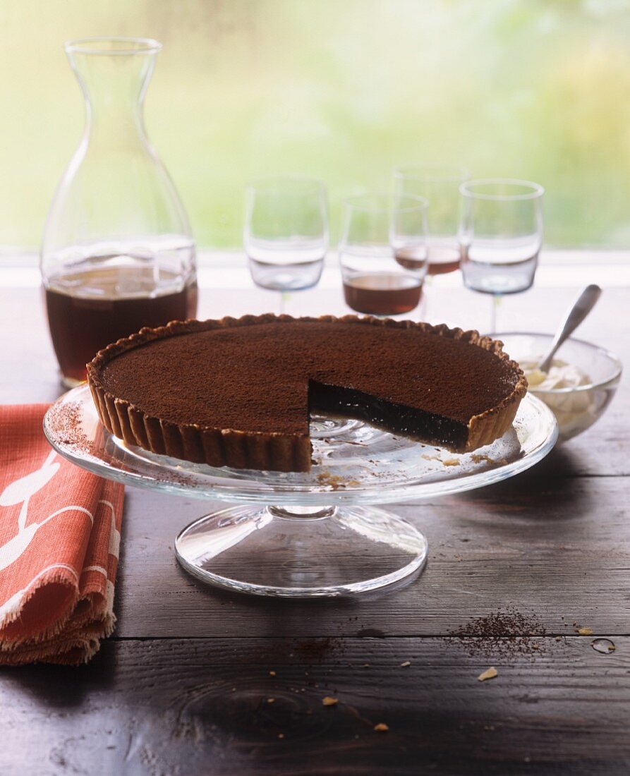 A chocolate mousse tart with a piece removed
