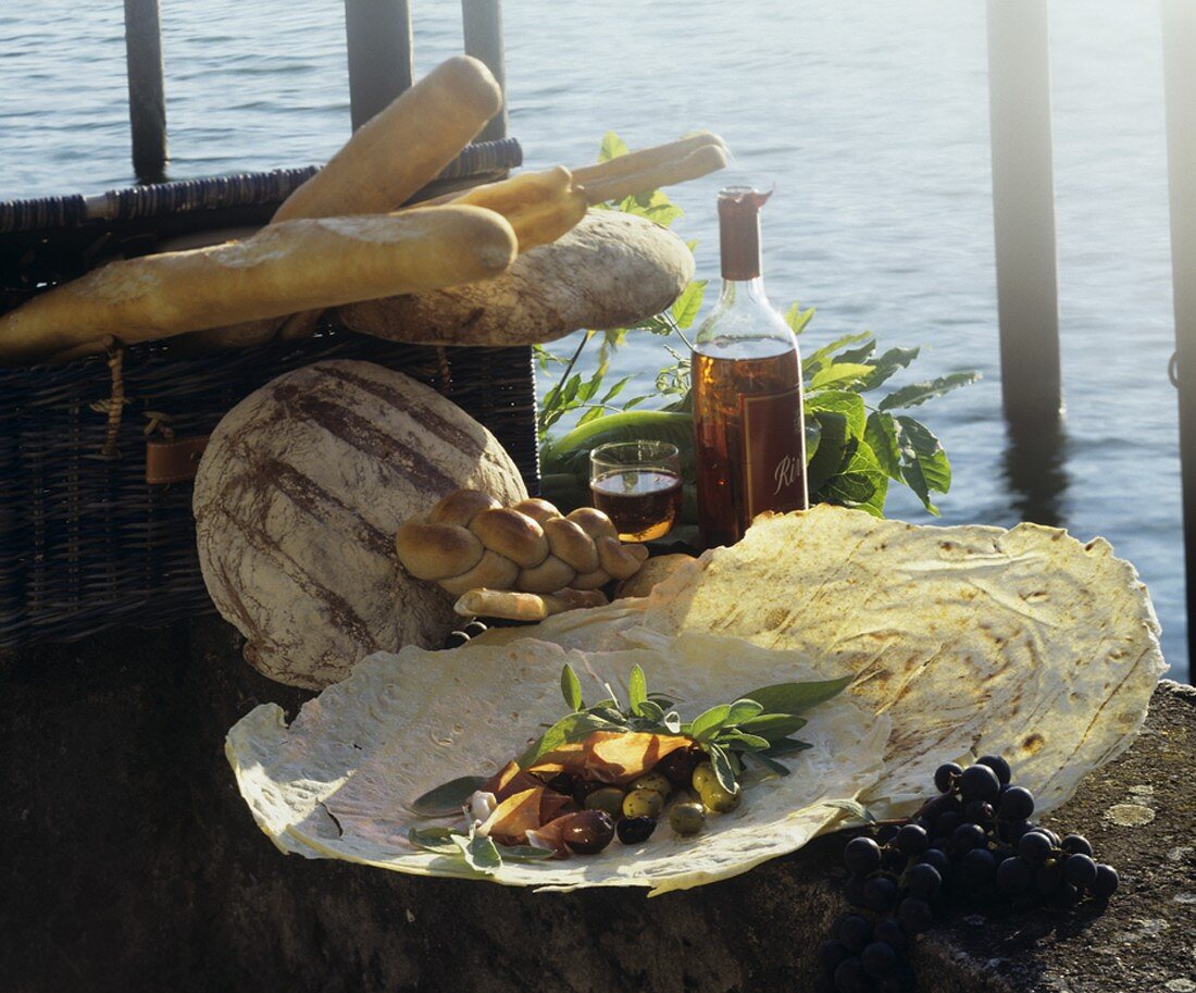 Sardinian bread with olives and ham by sea