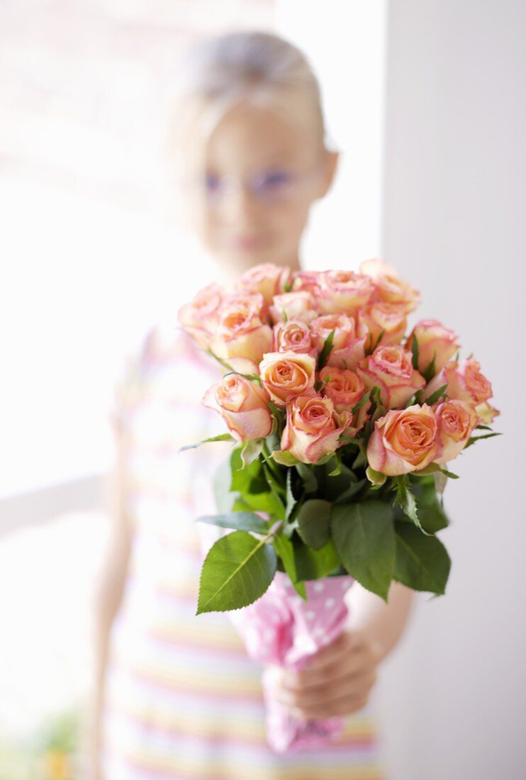 Girl holding a bouquet of roses