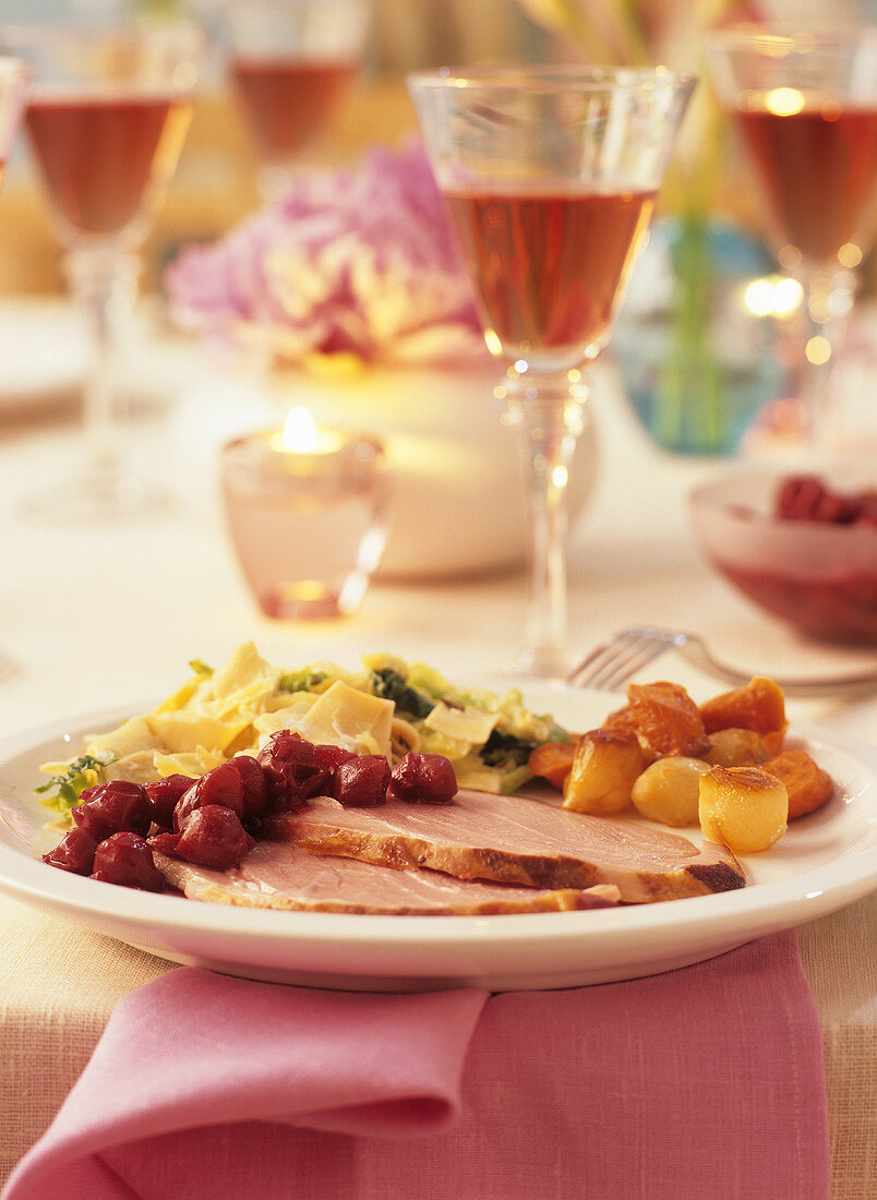 Roast pork with sour cherries, savoy cabbage, pasta & vegetables