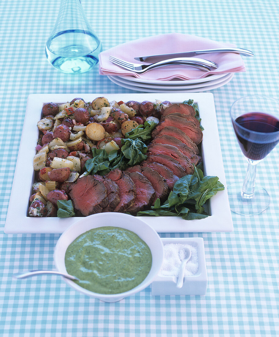 Beef fillet on chard with vegetables and herb sauce