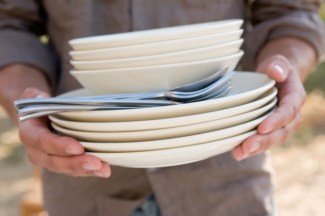 Hands holding crockery