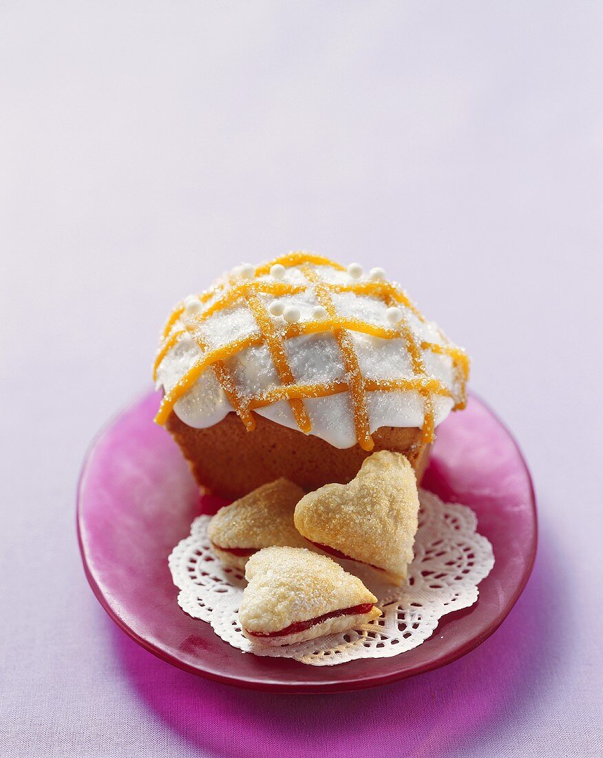 Small loaf cake and heart-shaped biscuits filled with jam