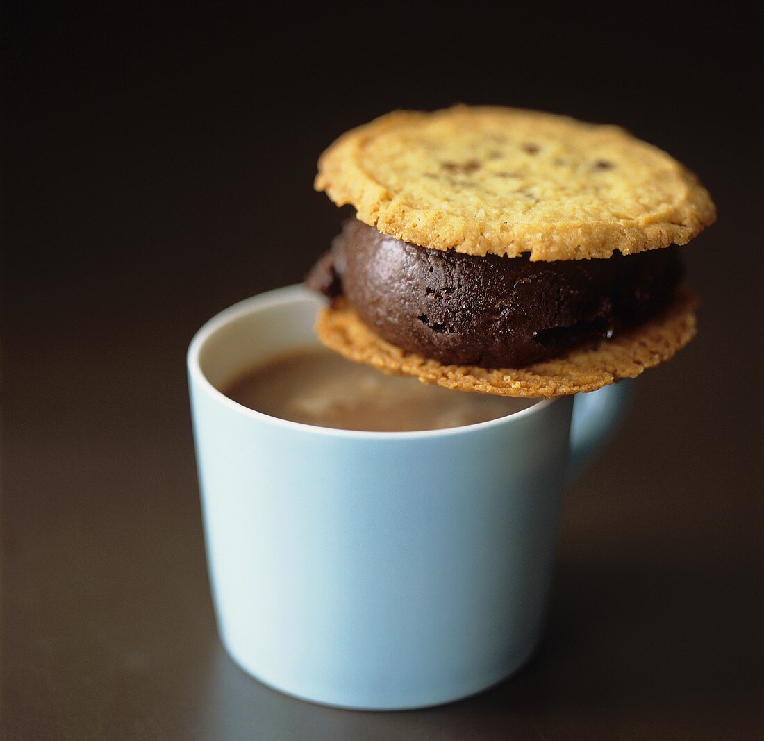 Chocolate sandwich (made with biscuits) & cup of hot chocolate
