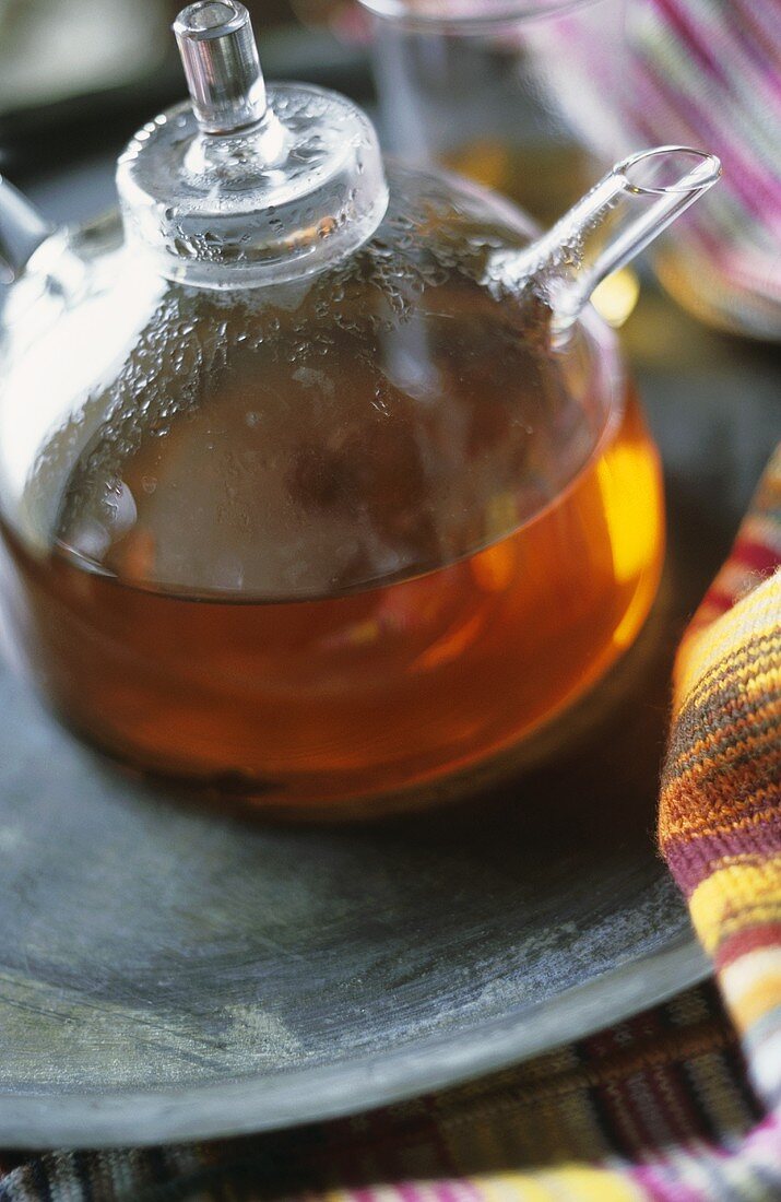 Herbal tea in glass teapot