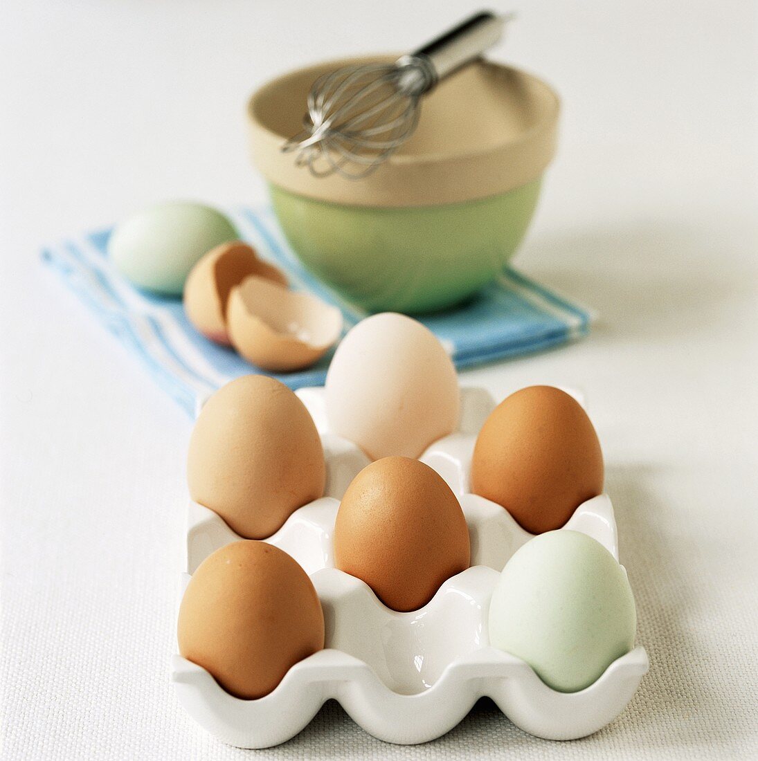 Eggs (brown, white and blue-green) in egg holder