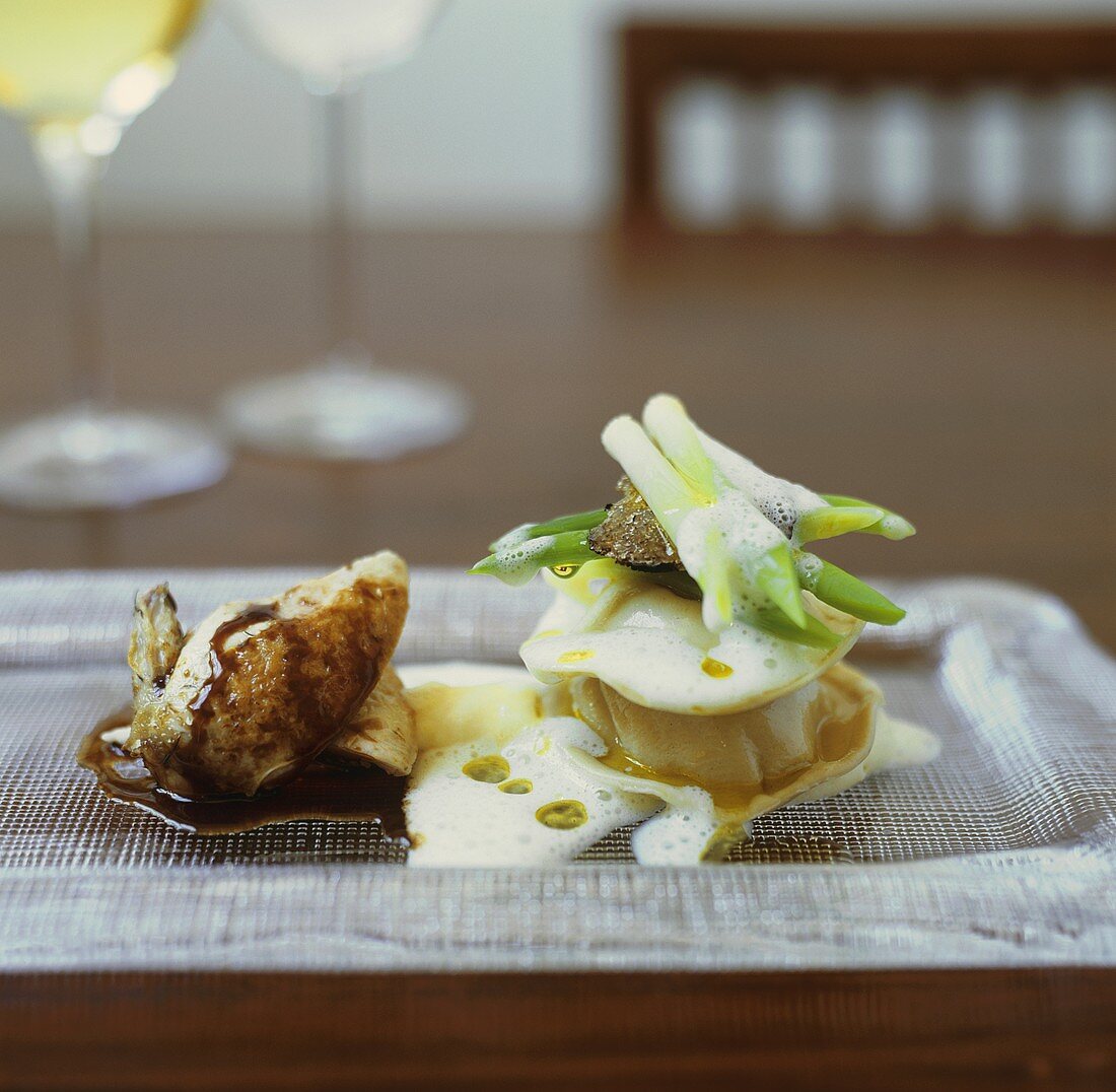 Chicken wing with potato ravioli, truffle and foam sauce
