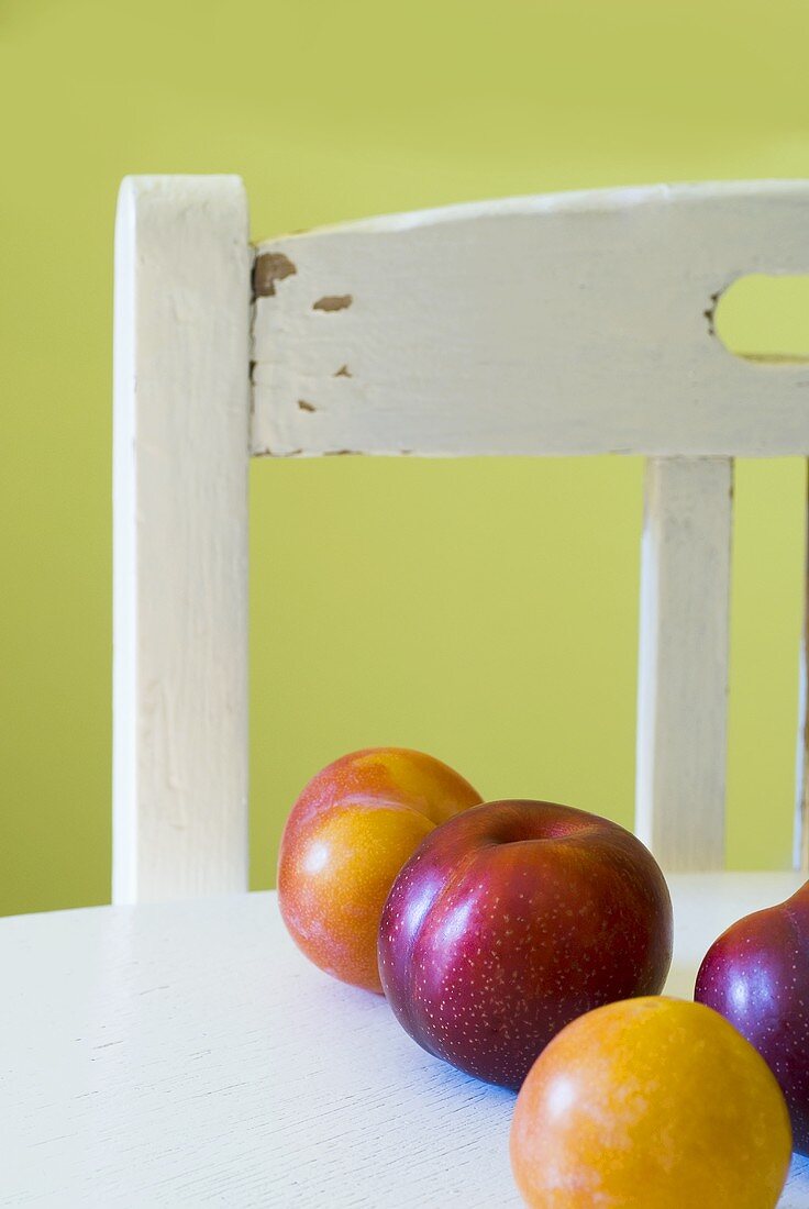 Yellow and red plums on a table