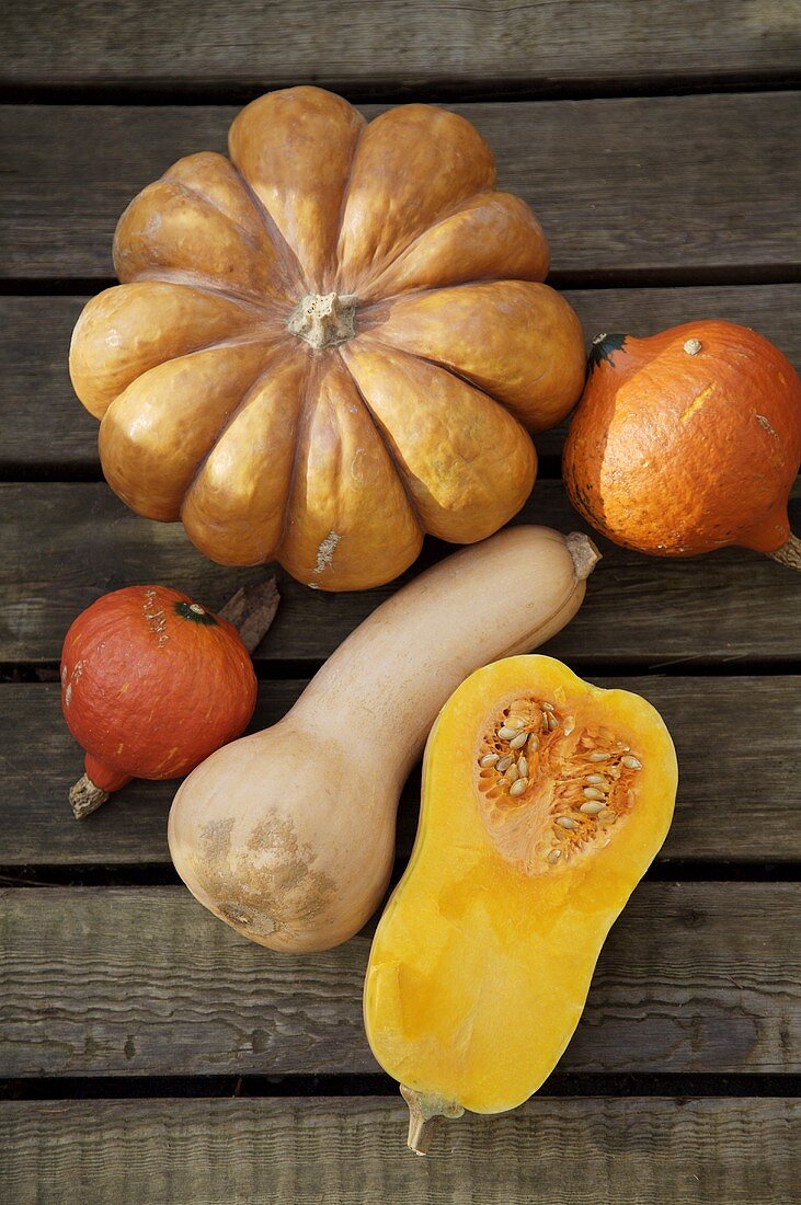 An assortment of pumpkins & squashes on wooden background