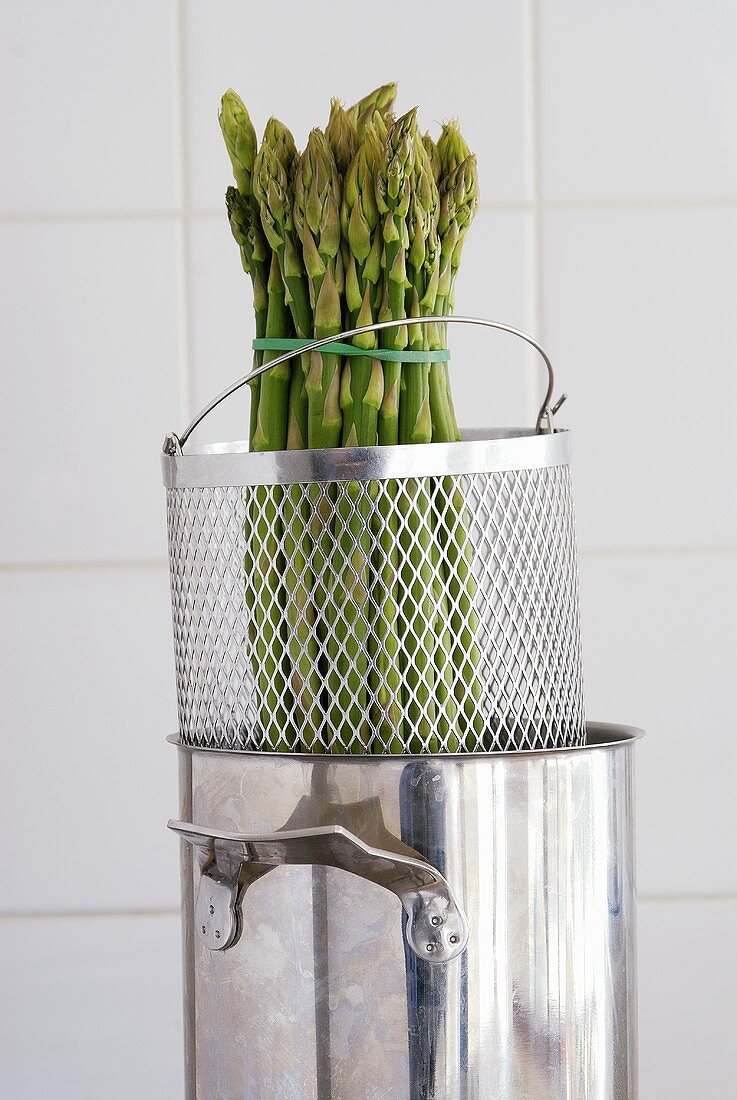 A bundle of green asparagus in an asparagus pan