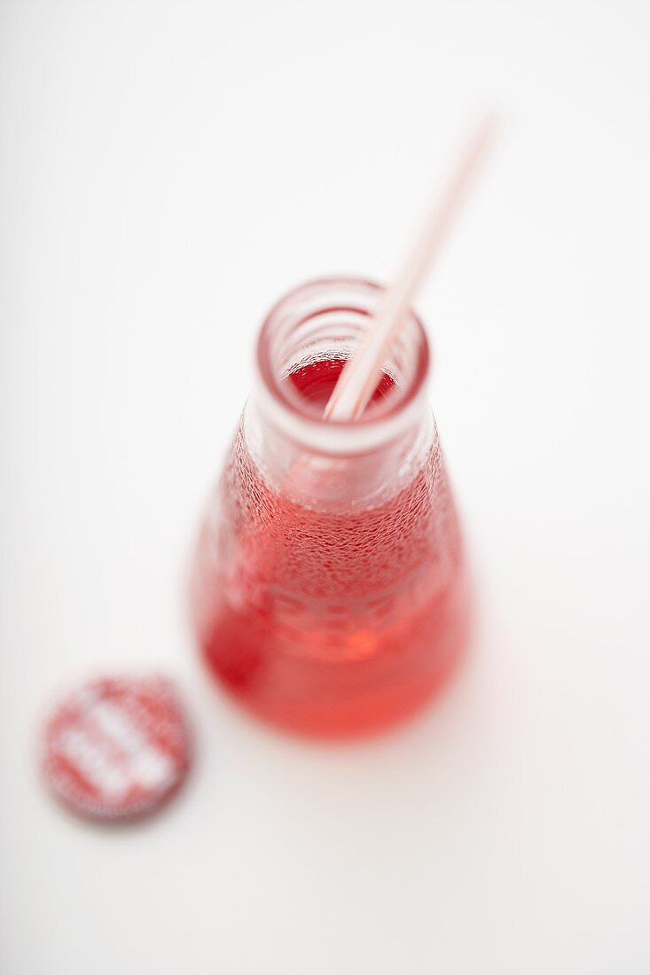 Campari soda in bottle with straw