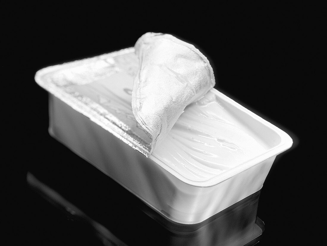Soft cheese in opened packaging