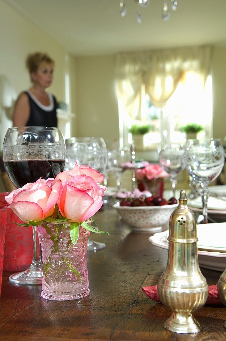 Wine and roses on laid table