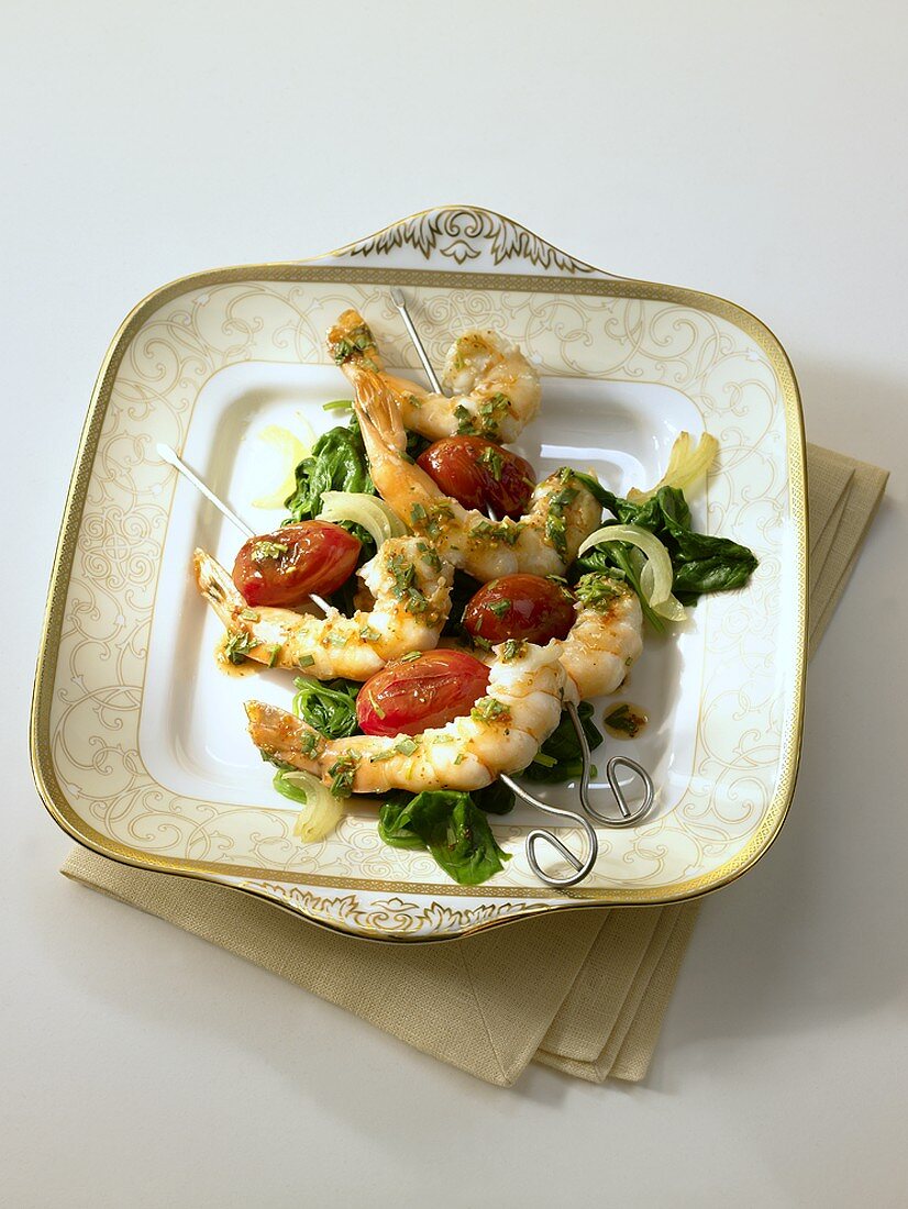 Skewered prawns and dates on bed of spinach