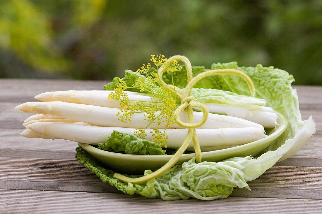 Fresh asparagus in a savoy cabbage leaf