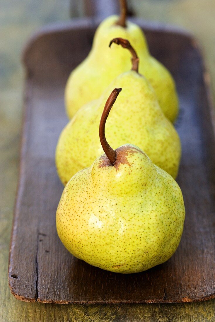 Three pears on a wooden board