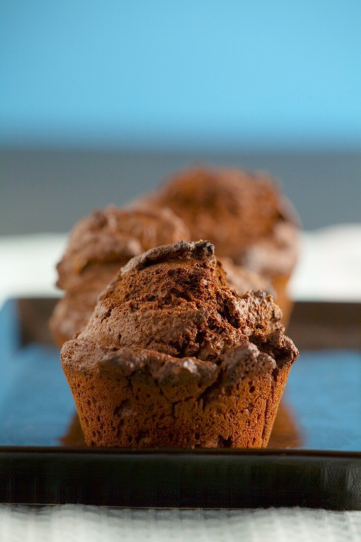Chocolate muffins on a baking tray