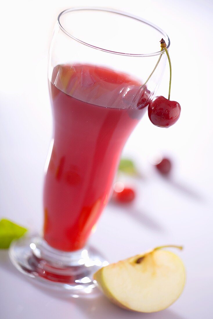 A glass of apple and cherry juice