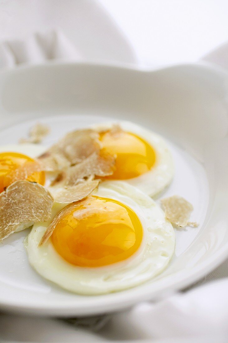 Three fried eggs with white truffle