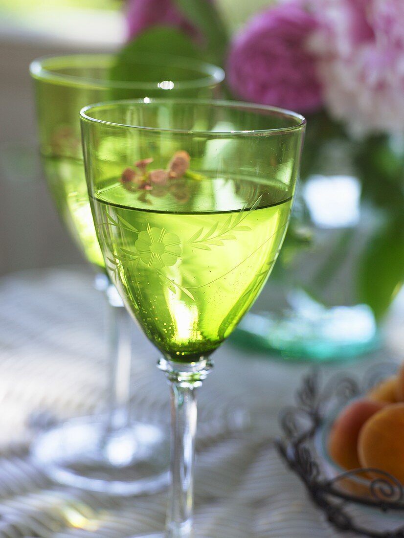 White wine in two green glasses