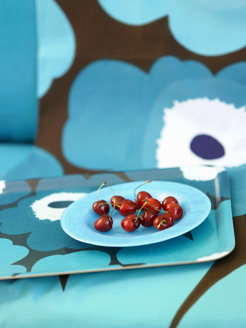 A plate of cherries on a tray