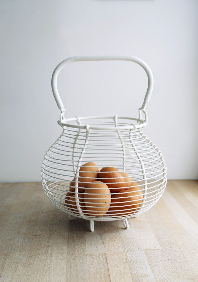 Several eggs in a wire basket