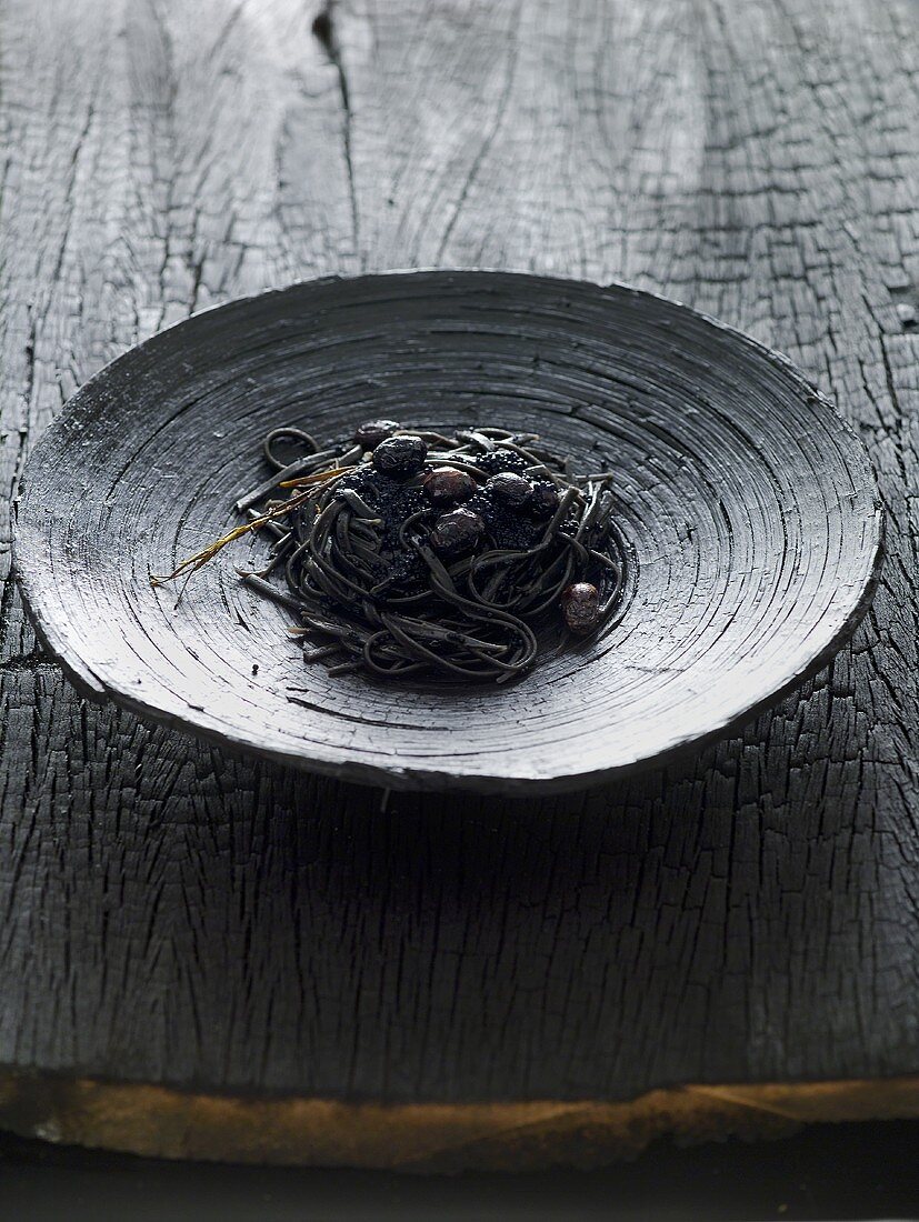 Black tagliatelle with olives and caviar