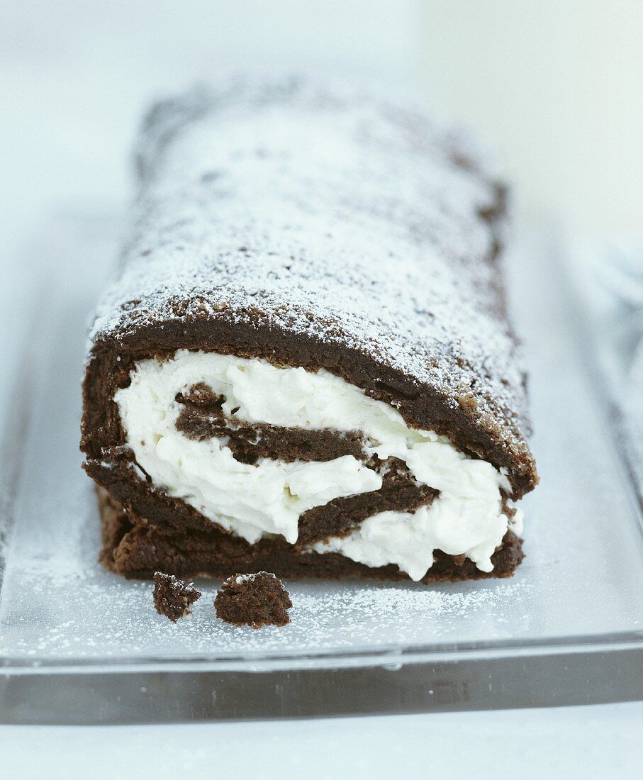 Chocolate sponge roulade filled with whipped cream