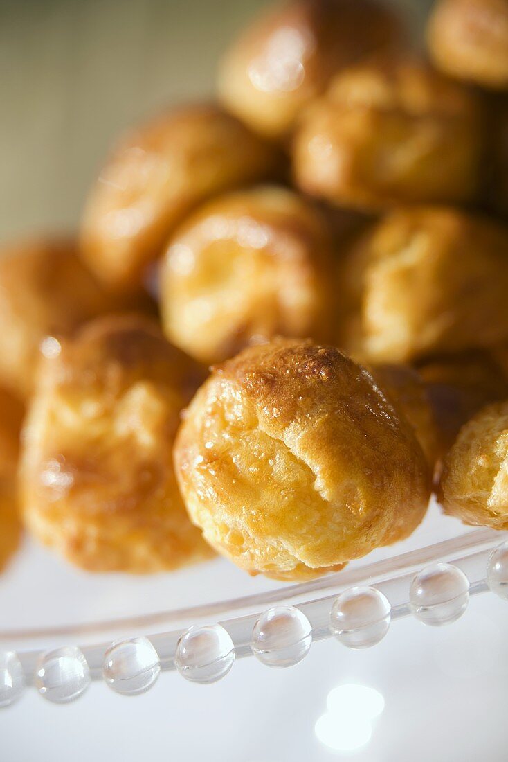 Gougères (cheese puffs, France) on a glass plate