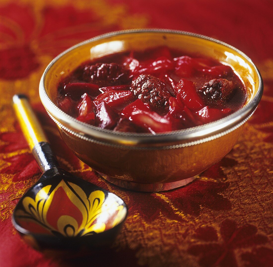 A bowl of borscht with Russian spoon