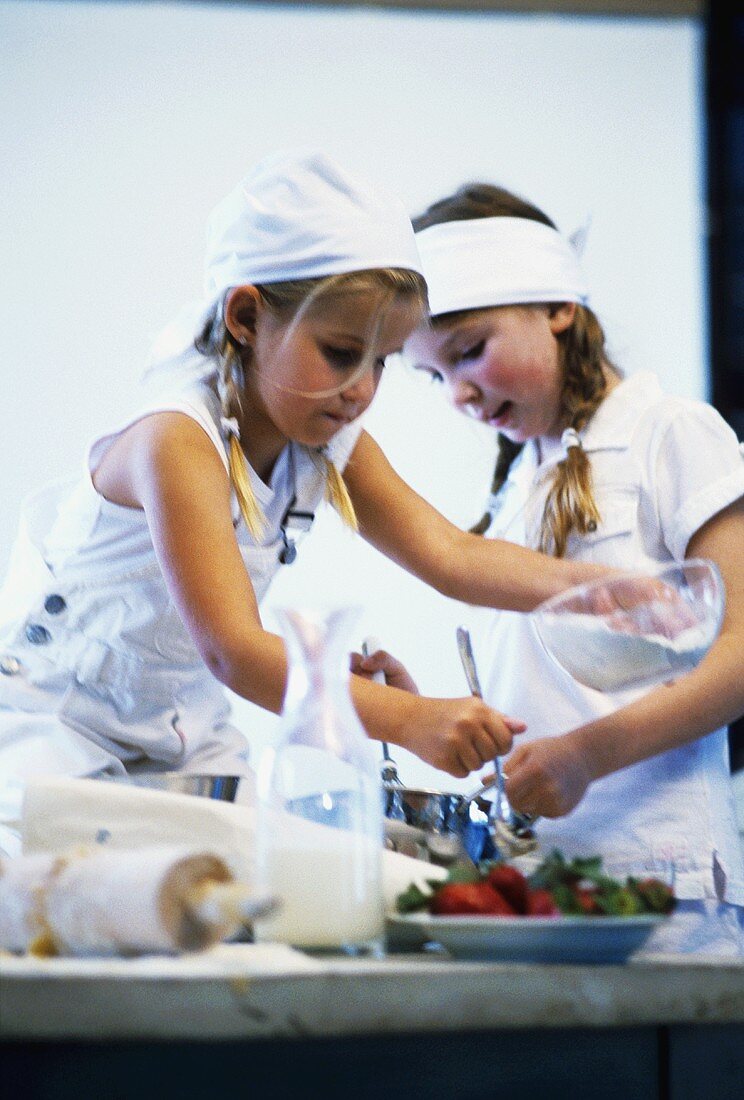 Two little girls baking