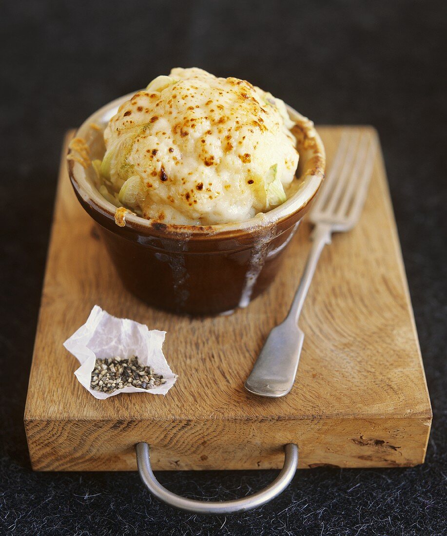 Cauliflower au gratin on wooden board