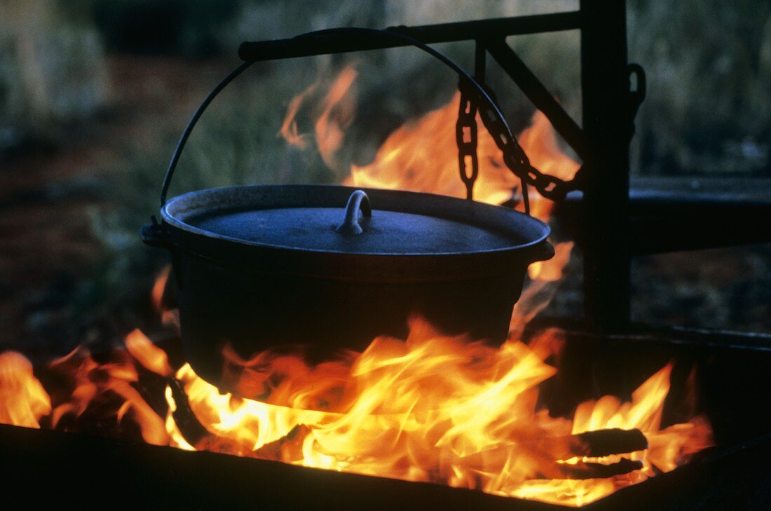 An Iron Pot Hanging over an Open Flame