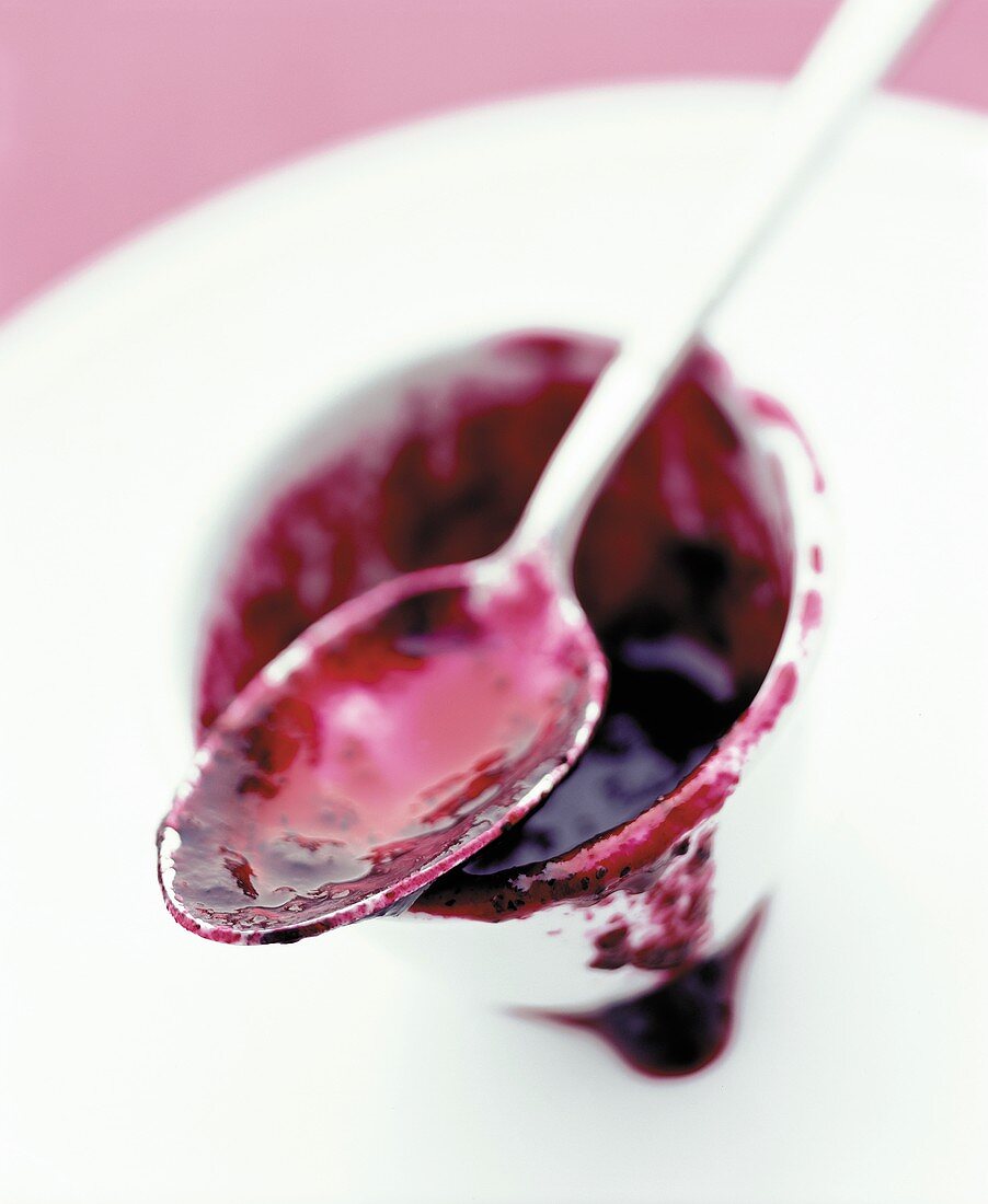 A spoon with red jam