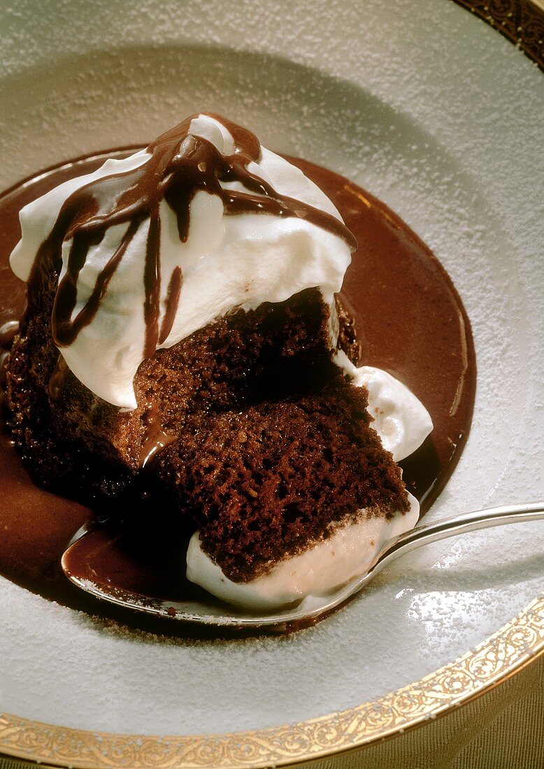 Chocolate Souffle Covered in Cream in Chocolate Sauce