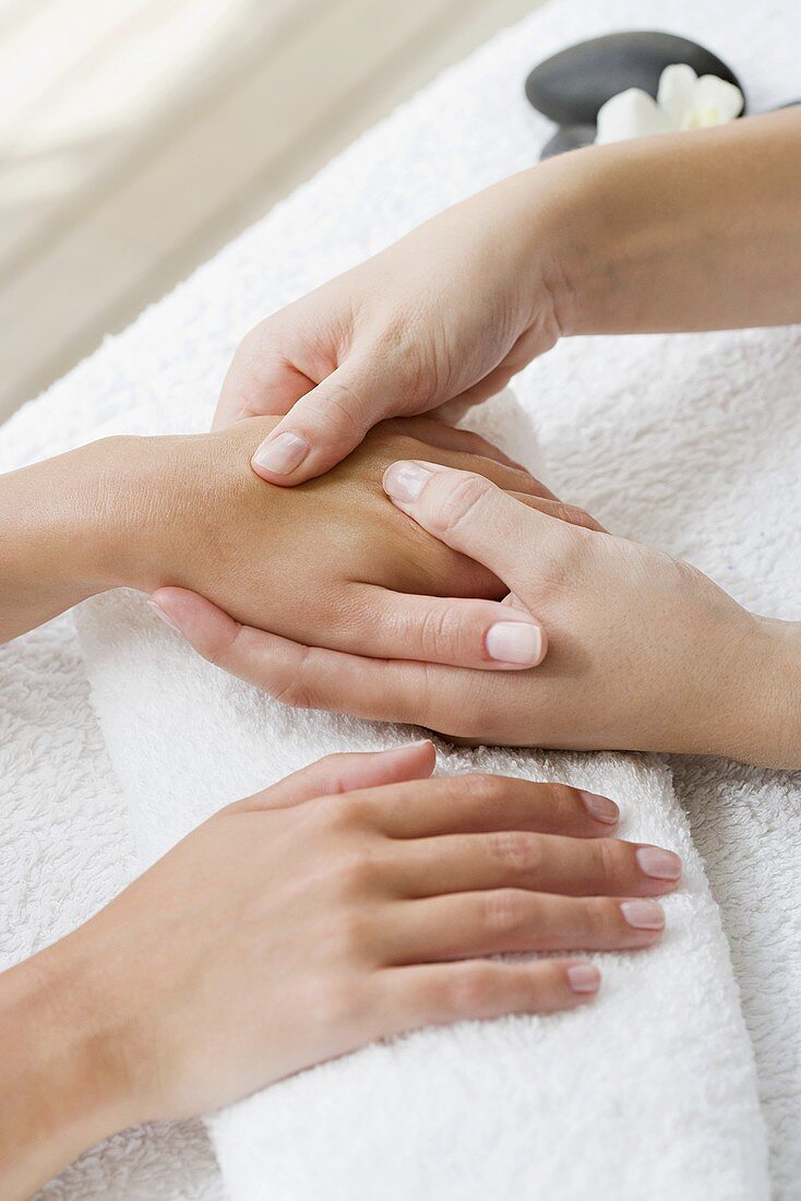 A woman receiving a hand massage