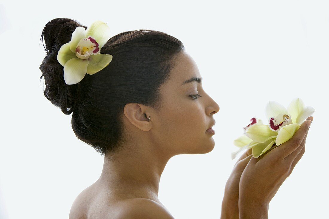 Young woman holding an orchid flower